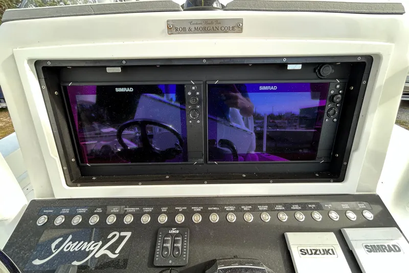 Slide: The Image of Control panel of a 2022 Young Boats 27 with dual Simrad displays. - 15