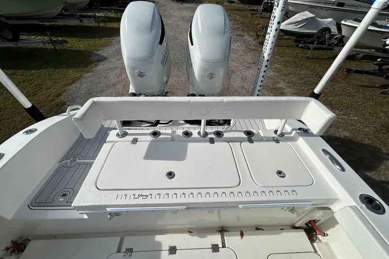 Slide: The Image of 2022 Young Boats 27 with dual Suzuki outboard engines, featuring a spacious deck layout. - 20