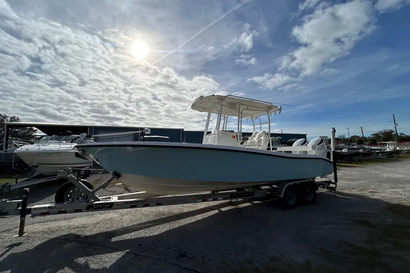 Slide: The Image of 2022 Young Boats 27 on trailer under cloudy sky, ready for adventure. - 3
