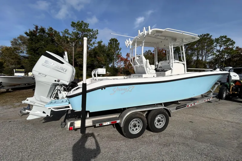 Slide: The Image of 2022 Young Boats 27 on trailer with Suzuki outboard, parked outdoors. - 6