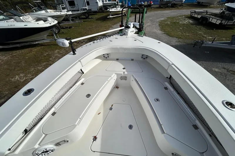 Slide: The Image of 2022 Young Boats 27 model, spacious deck view with storage compartments and fishing gear. - 8