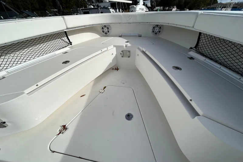 Slide: The Image of Spacious interior of 2022 Young Boats 27 model, featuring storage compartments and netting. - 9