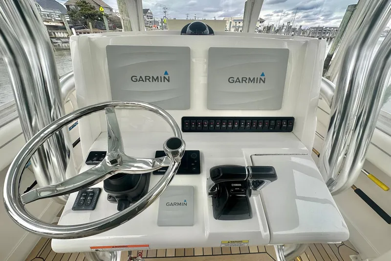 Slide: The Image of 2013 Jupiter 30 Center Console helm with Garmin displays and controls. - 10