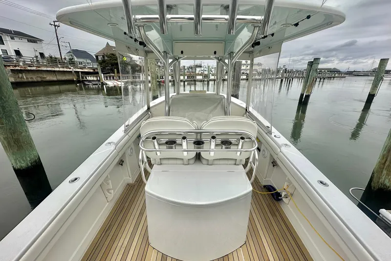 Slide: The Image of 2013 Jupiter 30 Center Console boat docked, featuring sleek design and spacious deck. - 15