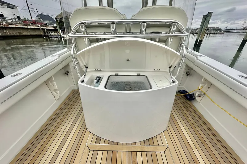 Slide: The Image of 2013 Jupiter 30 Center Console boat interior with teak flooring and fishing station. - 17