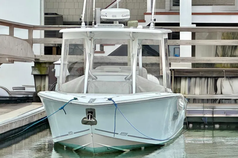 Slide: The Image of 2013 Jupiter 30 Center Console boat docked in marina. - 2