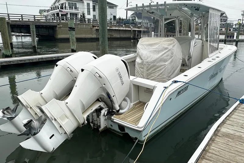 Slide: The Image of 2013 Jupiter 30 Center Console boat docked with twin Yamaha outboard engines. - 3
