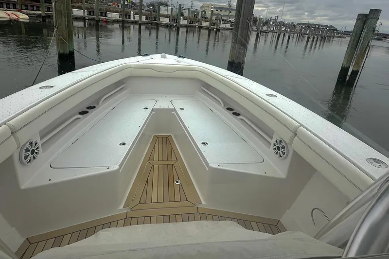 Slide: The Image of 2013 Jupiter 30 Center Console boat interior with seating and speakers at dock. - 6