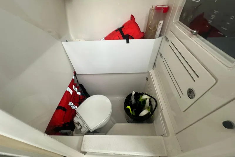 Slide: The Image of Interior of 2013 Jupiter 30 Center Console boat with life jackets and toilet. - 8