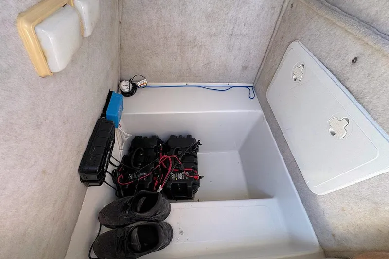 Slide: The Image of 2006 Sea Pro 238 Center Console interior with battery compartment and storage. - 10