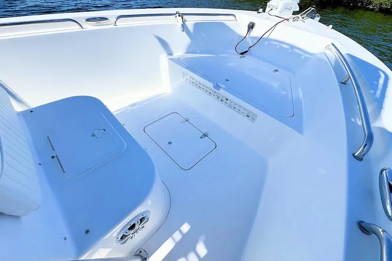 Slide: The Image of 2006 Sea Pro 238 Center Console boat interior with storage compartments and seating. - 12