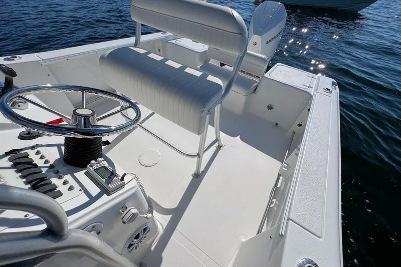 Slide: The Image of 2006 Sea Pro 238 Center Console boat interior with steering wheel and seating. - 6