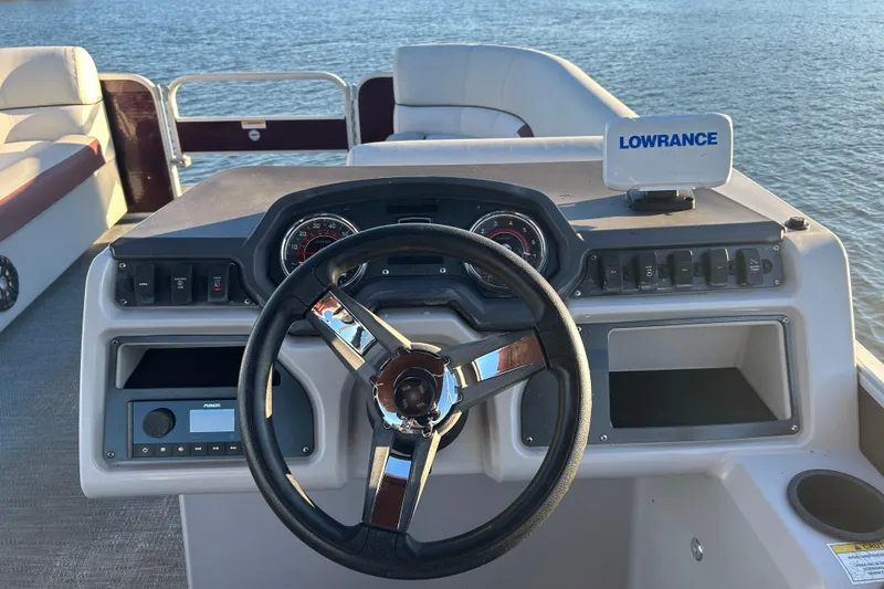 Slide: The Image of 2023 Godfrey Sweetwater 2286 C boat dashboard with steering wheel and Lowrance device. - 10