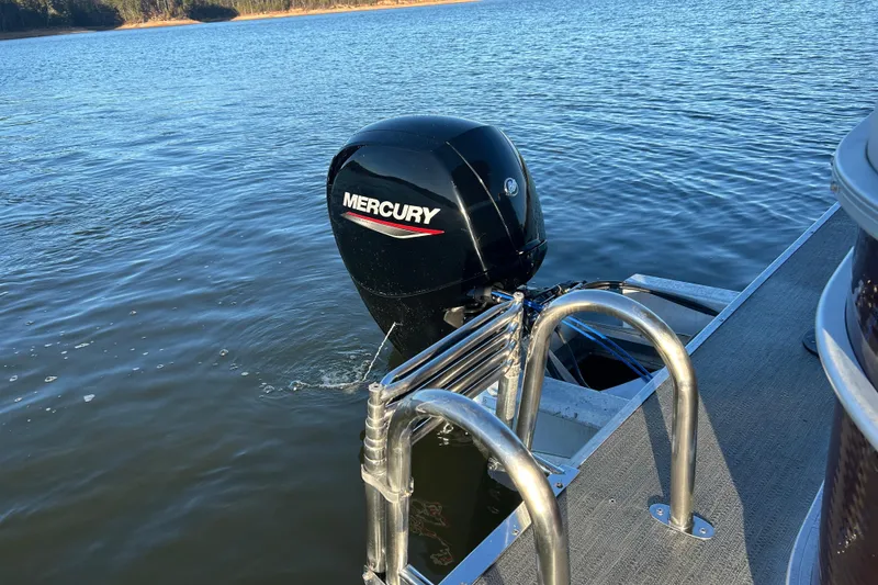 Slide: The Image of 2023 Godfrey Sweetwater 2286 C pontoon boat with Mercury outboard motor on a lake. - 13