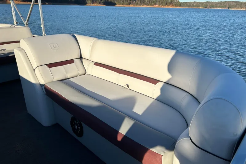 Slide: The Image of 2023 Godfrey Sweetwater 2286 C pontoon boat with comfortable seating on a serene lake. - 14