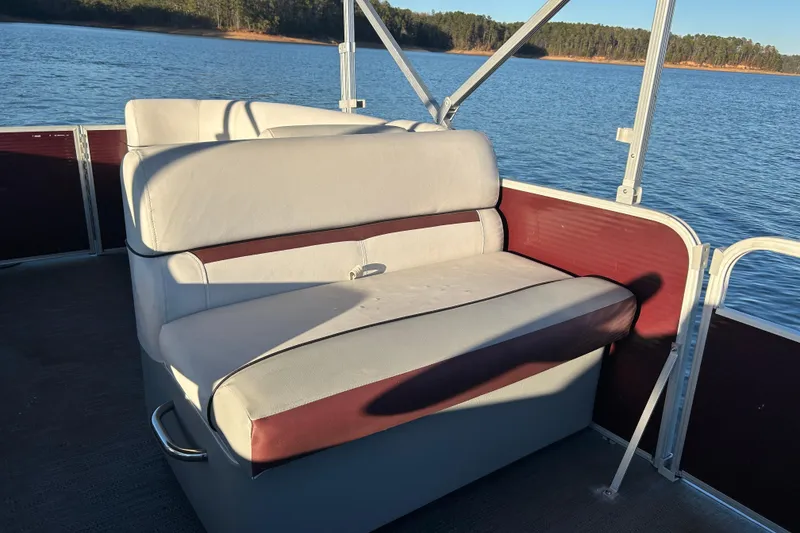 Slide: The Image of 2023 Godfrey Sweetwater 2286 C pontoon boat seating on a calm lake. - 16