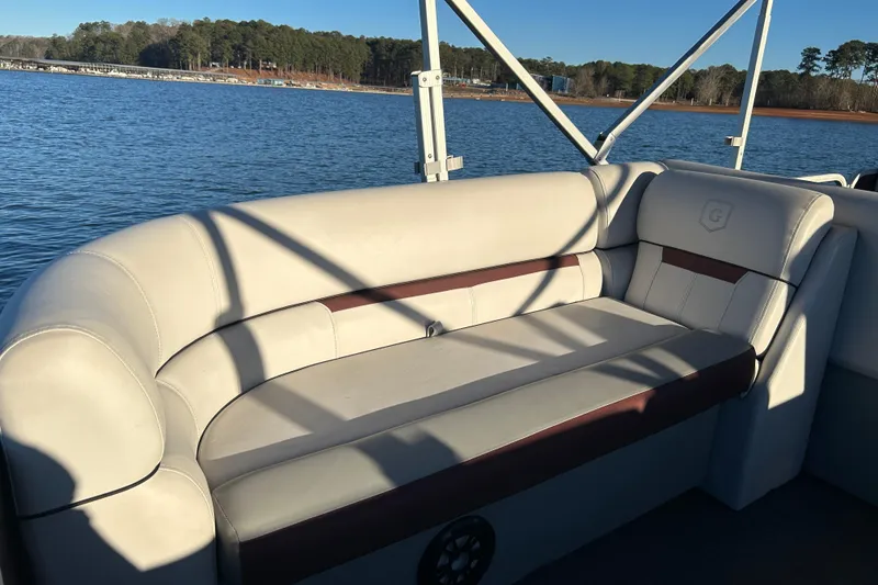 Slide: The Image of 2023 Godfrey Sweetwater 2286 C pontoon boat interior with comfortable seating on a sunny day. - 18