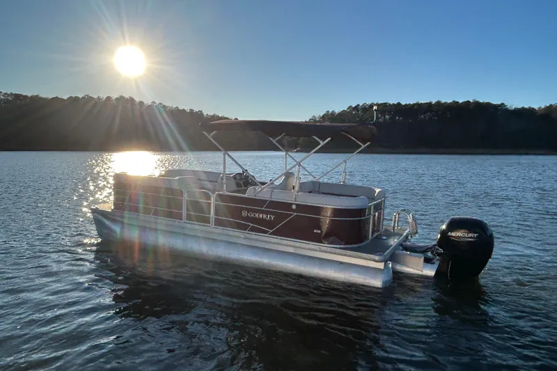 Slide: The Image of 2023 Godfrey Sweetwater 2286 C pontoon boat on a sunny lake. - 4