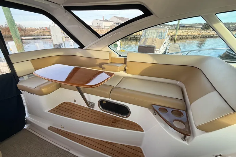Slide: The Image of Luxurious interior of 2013 Tiara Yachts 3600 Coronet with elegant seating and wooden table. - 10