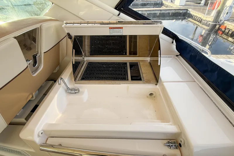 Slide: The Image of Outdoor kitchen area on a 2013 Tiara Yachts 3600 Coronet, featuring a sink and grill. - 12