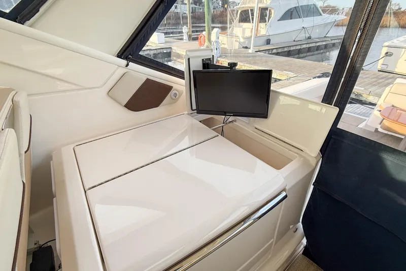Slide: The Image of Interior of 2013 Tiara Yachts 3600 Coronet with TV and storage compartment. - 13