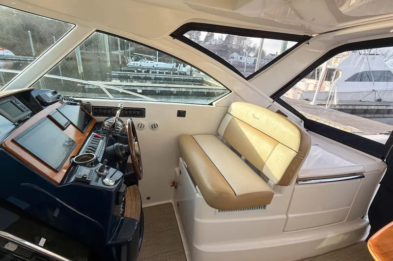 Slide: The Image of 2013 Tiara Yachts 3600 Coronet helm with beige seating and modern controls. - 14