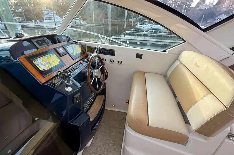 Slide: The Image of 2013 Tiara Yachts 3600 Coronet helm with navigation screens and beige seating. - 15