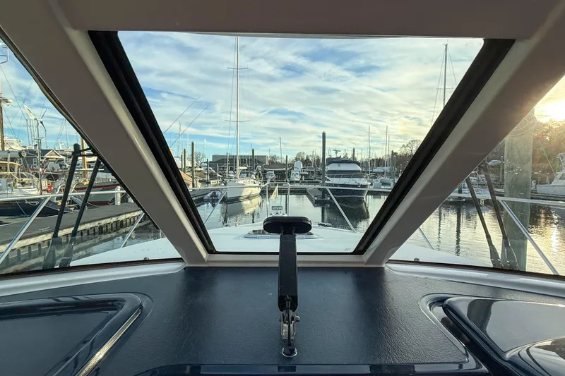 Slide: The Image of View from 2013 Tiara Yachts 3600 Coronet cockpit, overlooking marina with boats and clear sky. - 19