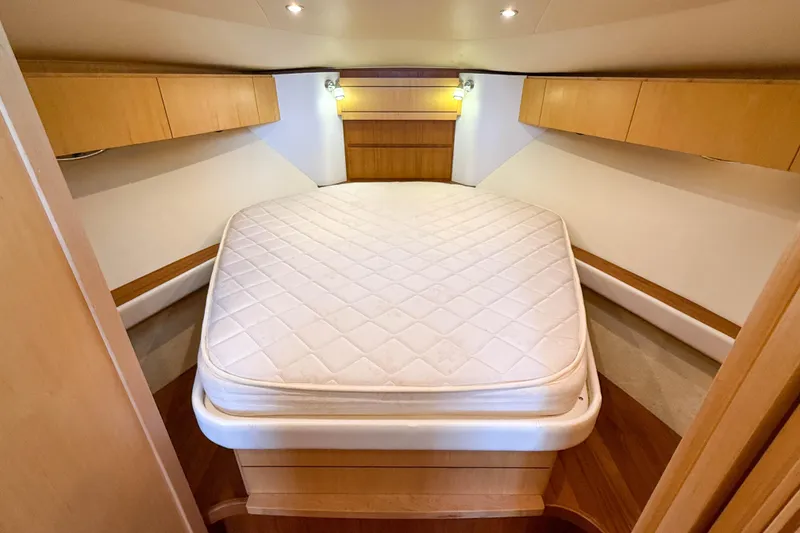 Slide: The Image of 2013 Tiara Yachts 3600 Coronet cabin with cozy bed and wooden cabinetry. - 21