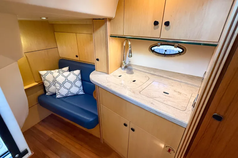 Slide: The Image of 2013 Tiara Yachts 3600 Coronet interior with kitchenette and seating area. - 25