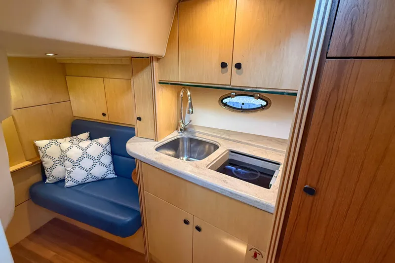 Slide: The Image of 2013 Tiara Yachts 3600 Coronet interior with kitchenette and seating area. - 26