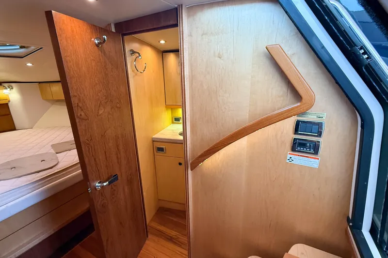 Slide: The Image of Interior of 2013 Tiara Yachts 3600 Coronet, featuring wood finishes and cozy cabin space. - 32