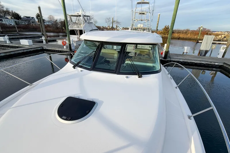 Slide: The Image of 2013 Tiara Yachts 3600 Coronet docked, showcasing sleek design and spacious deck. - 37