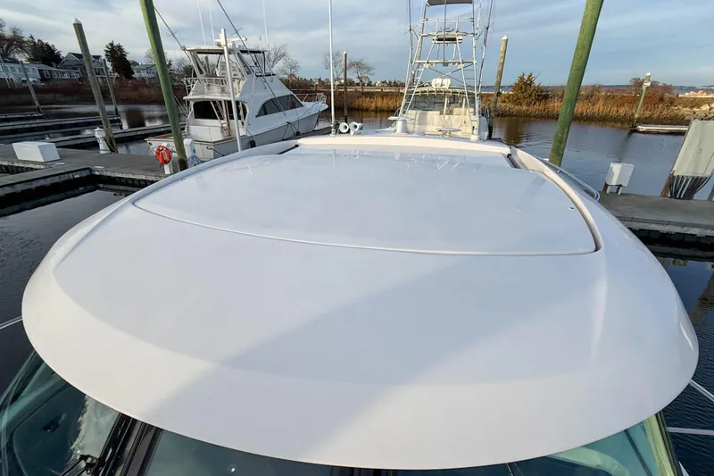 Slide: The Image of 2013 Tiara Yachts 3600 Coronet docked, showcasing sleek design and spacious deck. - 38