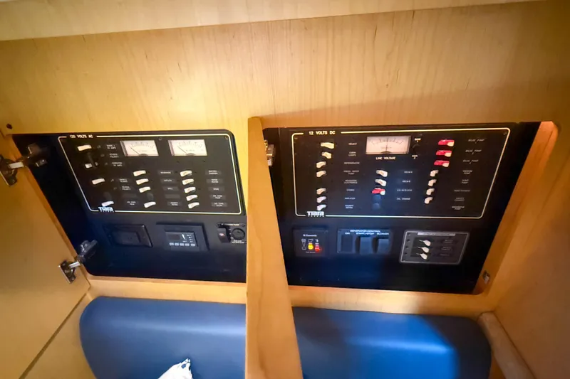 Slide: The Image of Control panel of a 2013 Tiara Yachts 3600 Coronet, featuring AC and DC switches. - 45