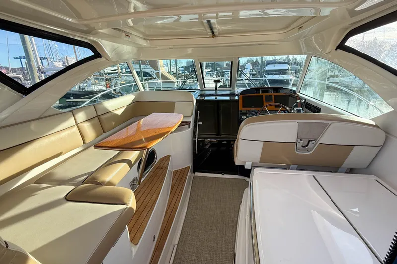 Slide: The Image of Interior of 2013 Tiara Yachts 3600 Coronet with beige seating and wooden accents. - 7