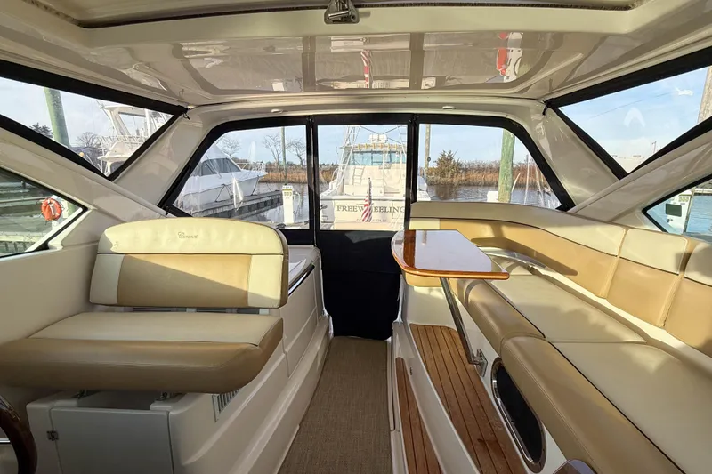 Slide: The Image of Interior of 2013 Tiara Yachts 3600 Coronet with beige seating and wooden table. - 8