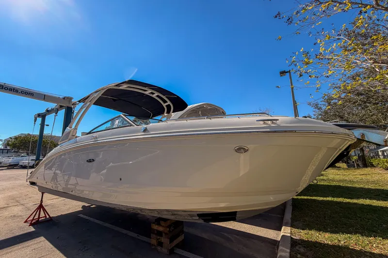 The Image of 2022 Sea Ray SDX 270 boat displayed outdoors under clear blue sky. - 0