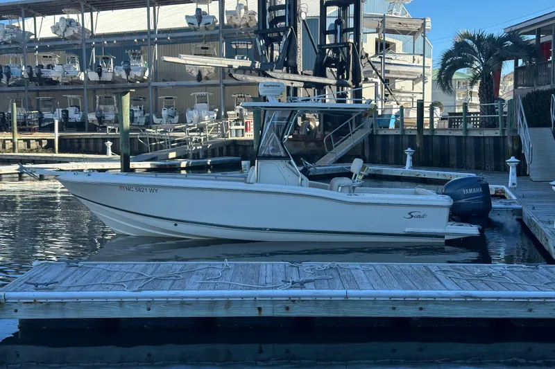 Slide: The Image of 2004 Scout 235 Sportfish boat docked at marina with Yamaha engine. - 0