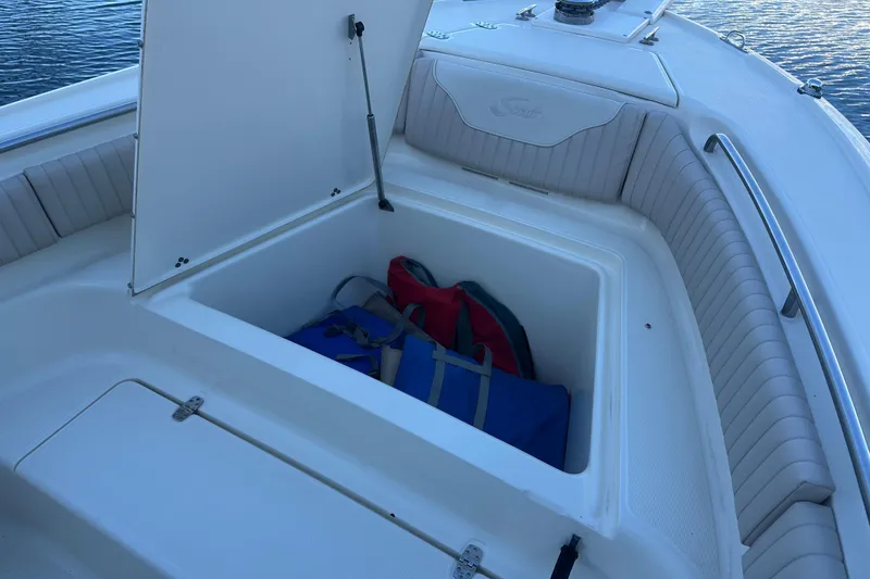 Slide: The Image of Open storage compartment on 2004 Scout 235 Sportfish boat with bags inside. - 11