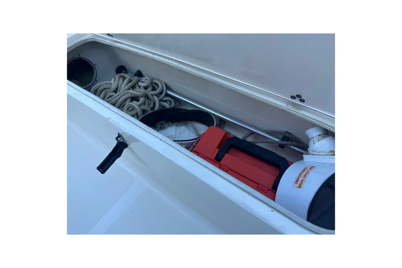 Slide: The Image of Storage compartment on a 2004 Scout 235 Sportfish boat with rope and equipment. - 12