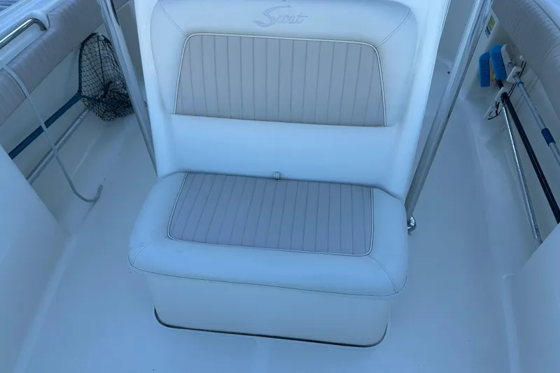 Slide: The Image of White cushioned seat on 2004 Scout 235 Sportfish boat interior. - 13