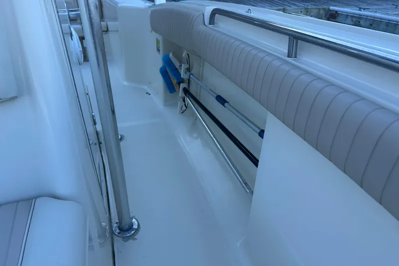 Slide: The Image of 2004 Scout 235 Sportfish boat interior with padded seating and stainless steel railings. - 14
