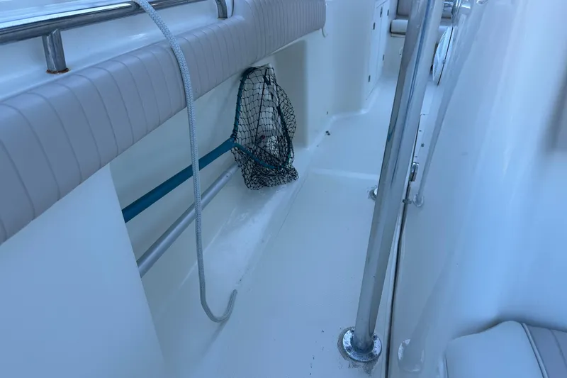 Slide: The Image of 2004 Scout 235 Sportfish boat interior with fishing net and railing. - 15