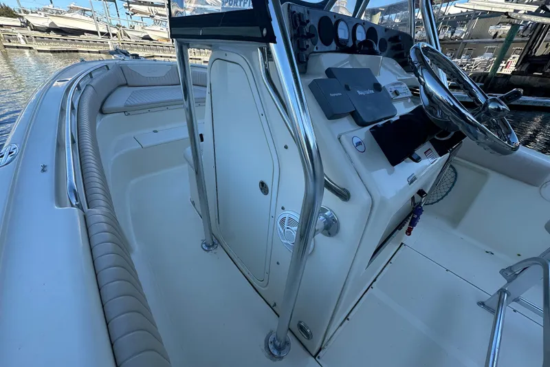 Slide: The Image of 2004 Scout 235 Sportfish boat interior with steering console and seating. - 17