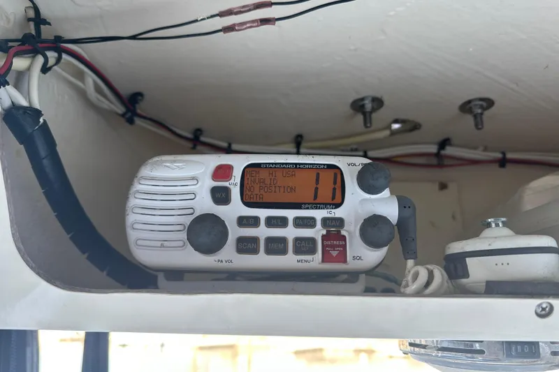 Slide: The Image of VHF radio on 2004 Scout 235 Sportfish boat, displaying channel information. - 23