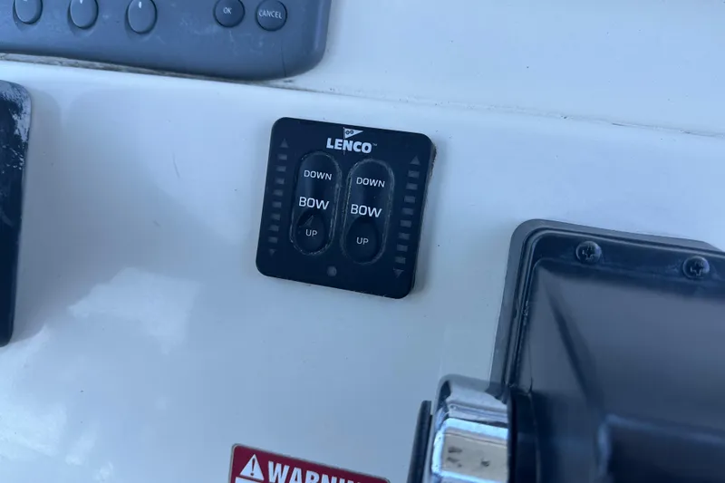 Slide: The Image of Control panel on a 2004 Scout 235 Sportfish boat with Lenco trim tab switches. - 27