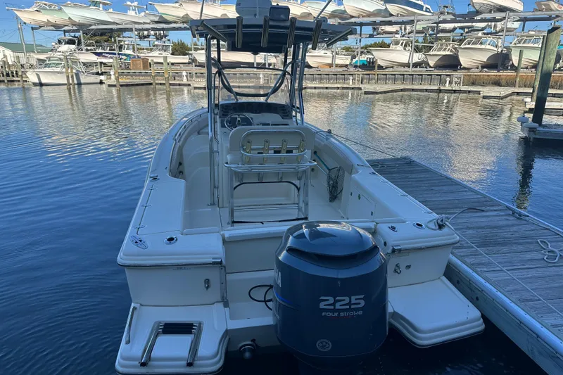 Slide: The Image of 2004 Scout 235 Sportfish boat docked with 225 horsepower engine. - 3