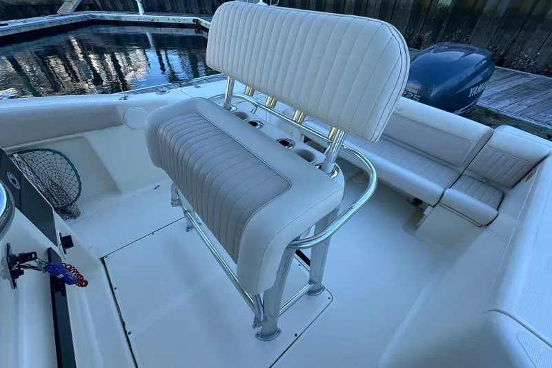 Slide: The Image of 2004 Scout 235 Sportfish boat interior with seating and fishing equipment. - 32