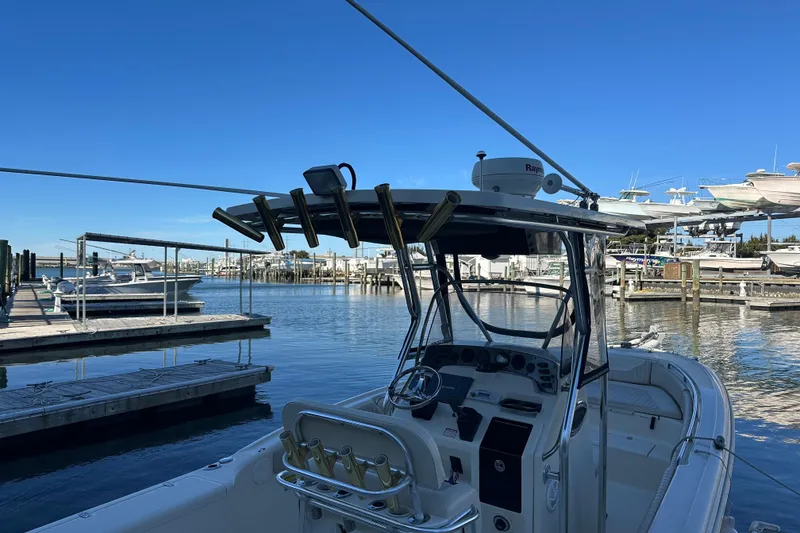 Slide: The Image of 2004 Scout 235 Sportfish boat docked at marina under clear blue sky. - 34